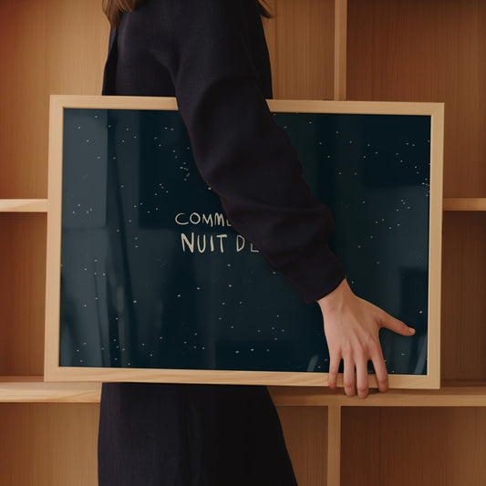 French night sky poster with stars in wood frame, carried by woman in dark clothing