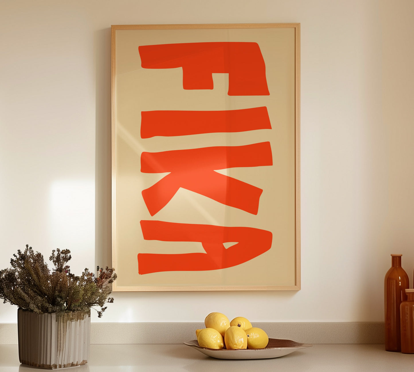 Minimalist kitchen poster with orange handwritten "Fika" on warm beige background.