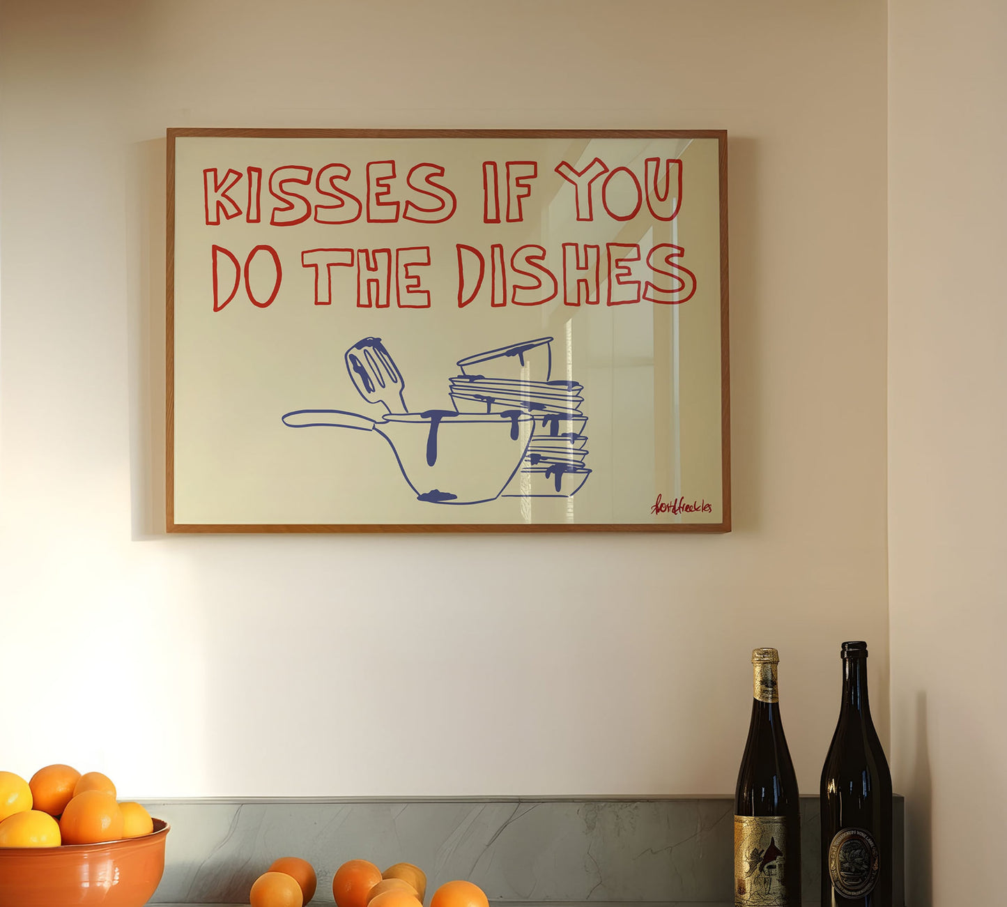 Playful kitchen poster reading "Kisses If You Do The Dishes" hanging above a modern kitchen counter