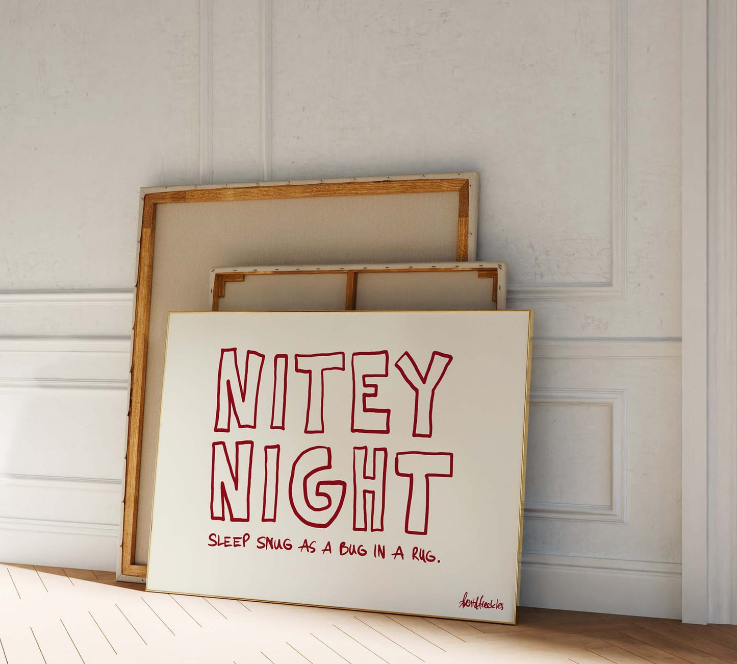 A picture frame leaning against a bedroom wall, bold red lettering reading "Nitey Night".