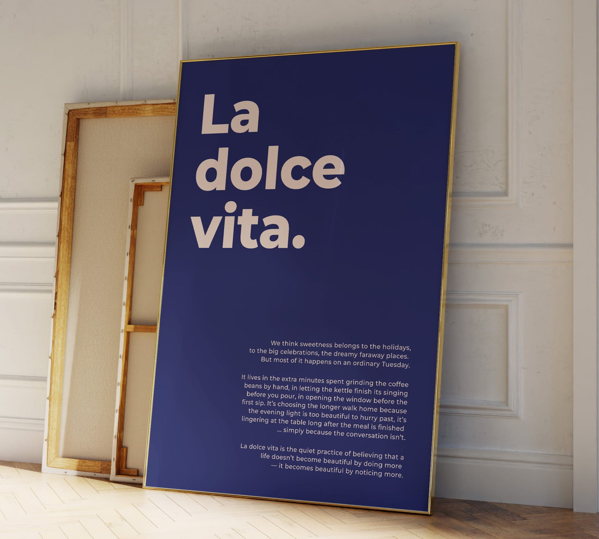 Lifestyle photo: The cobalt blue La dolce vita poster by Frost & Freckles styled in a bright, Scandinavian-inspired living room.