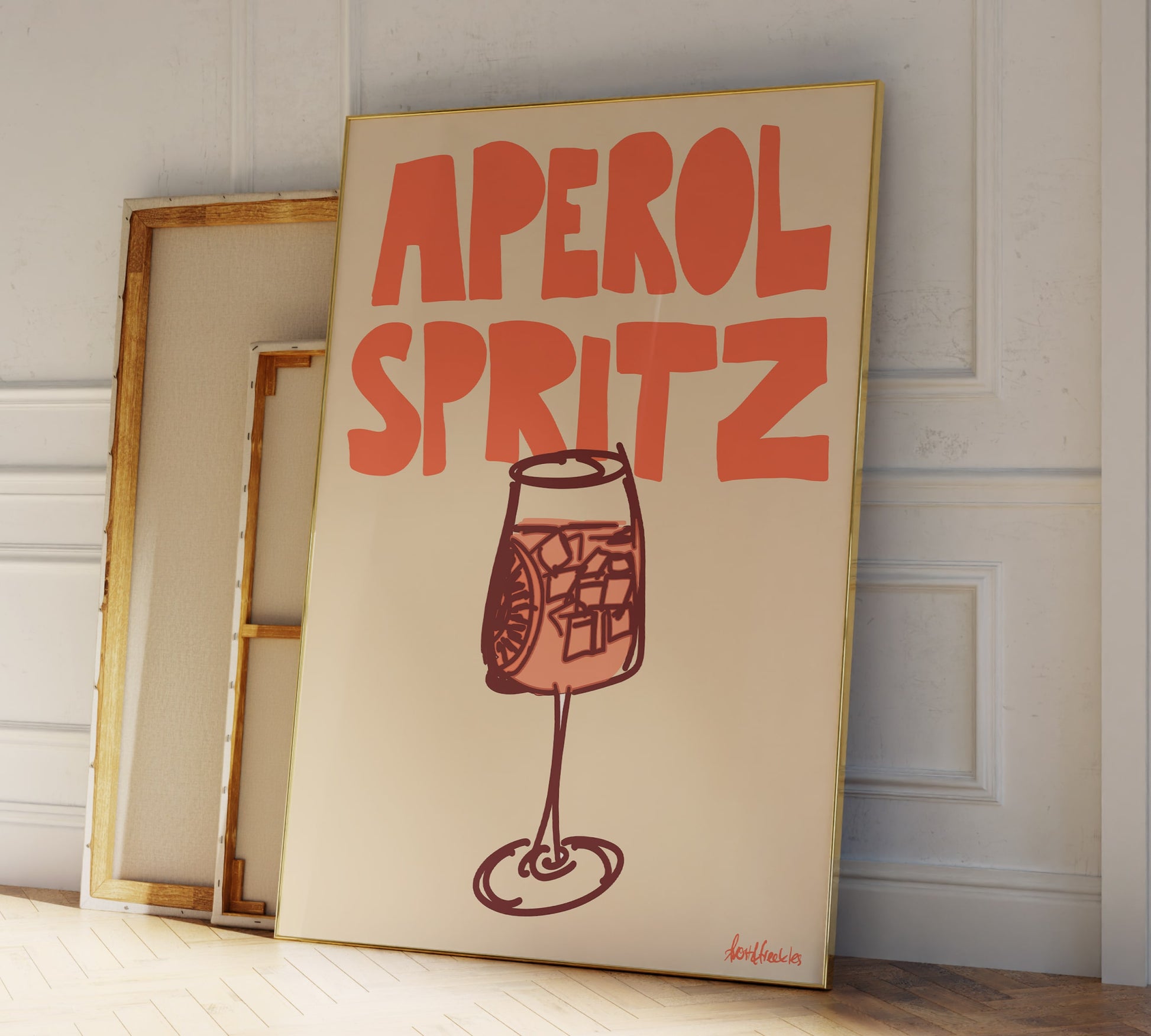 Framed Aperol Spritz art print styled as part of a gallery with warm boho kitchen vibes