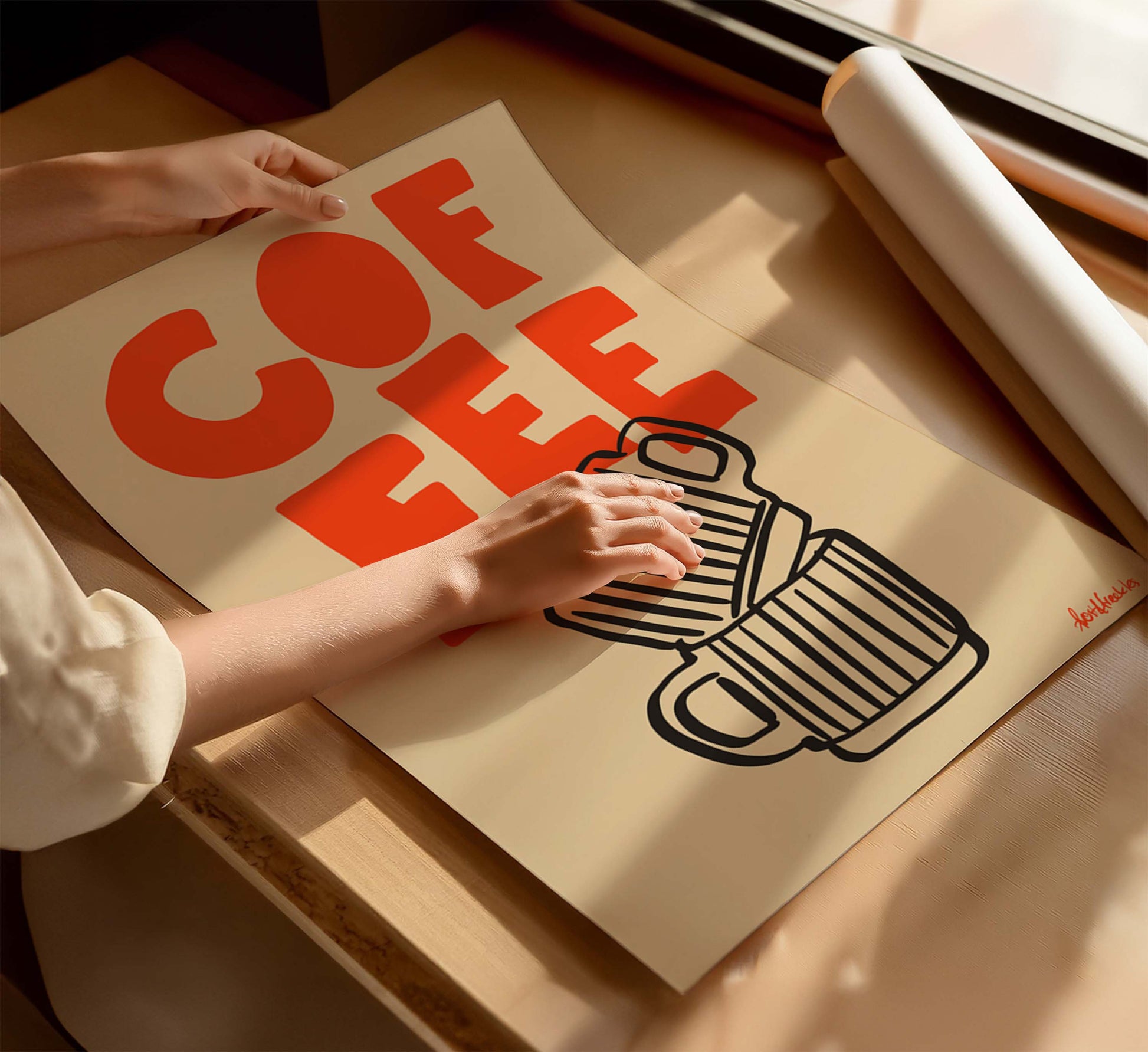 Close-up of modern coffee print with bold orange lettering on soft beige background