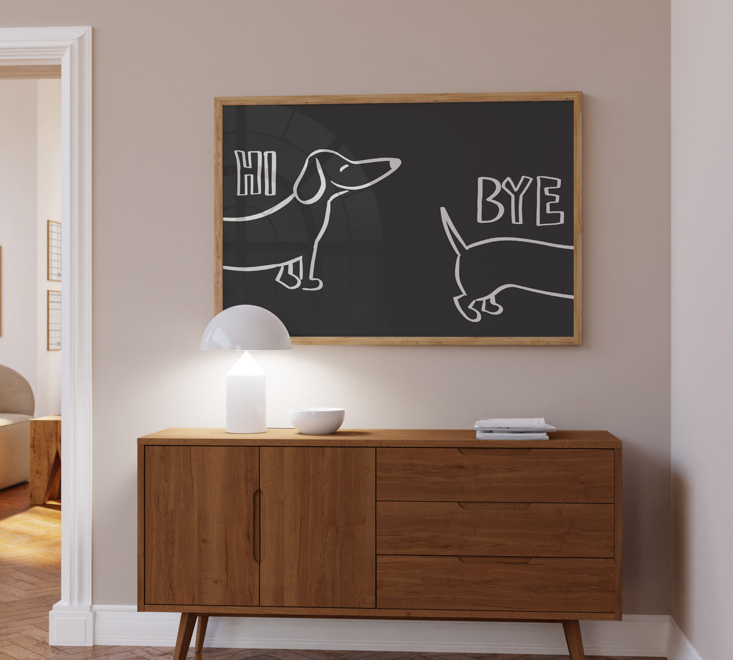 A bold black framed picture hanging above a sideboard, minimalist design showing a sausage cute dog illustration.
