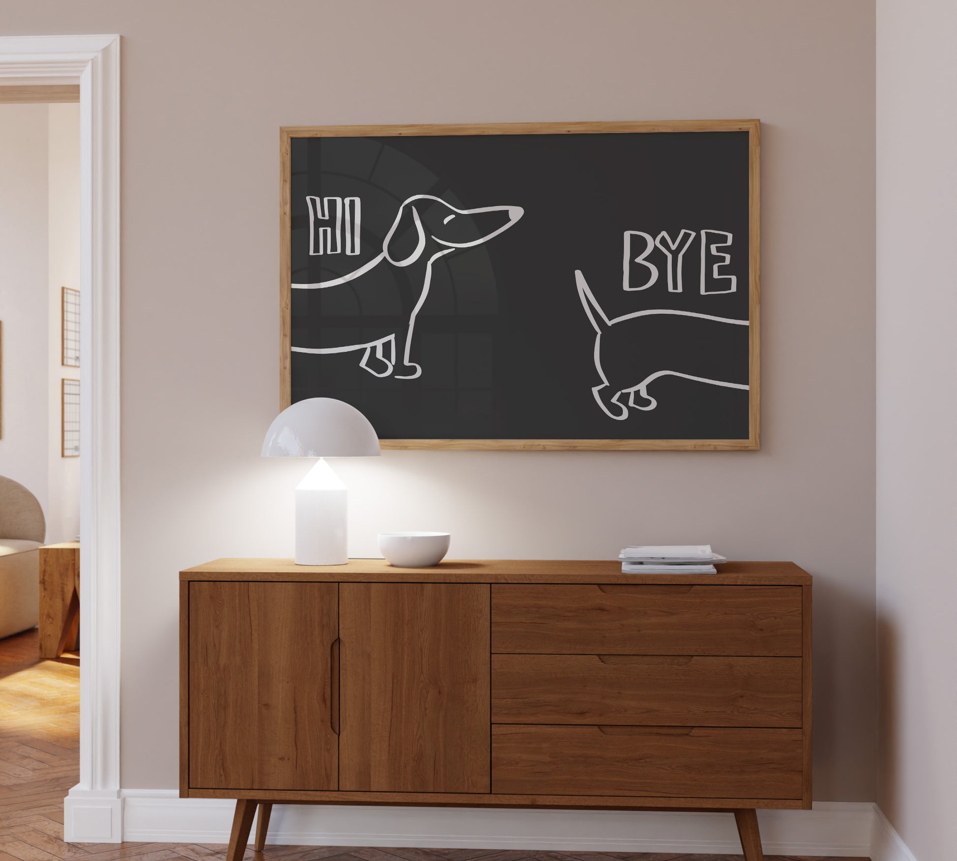 A bold black framed picture hanging above a sideboard, minimalist design showing a sausage cute dog illustration.
