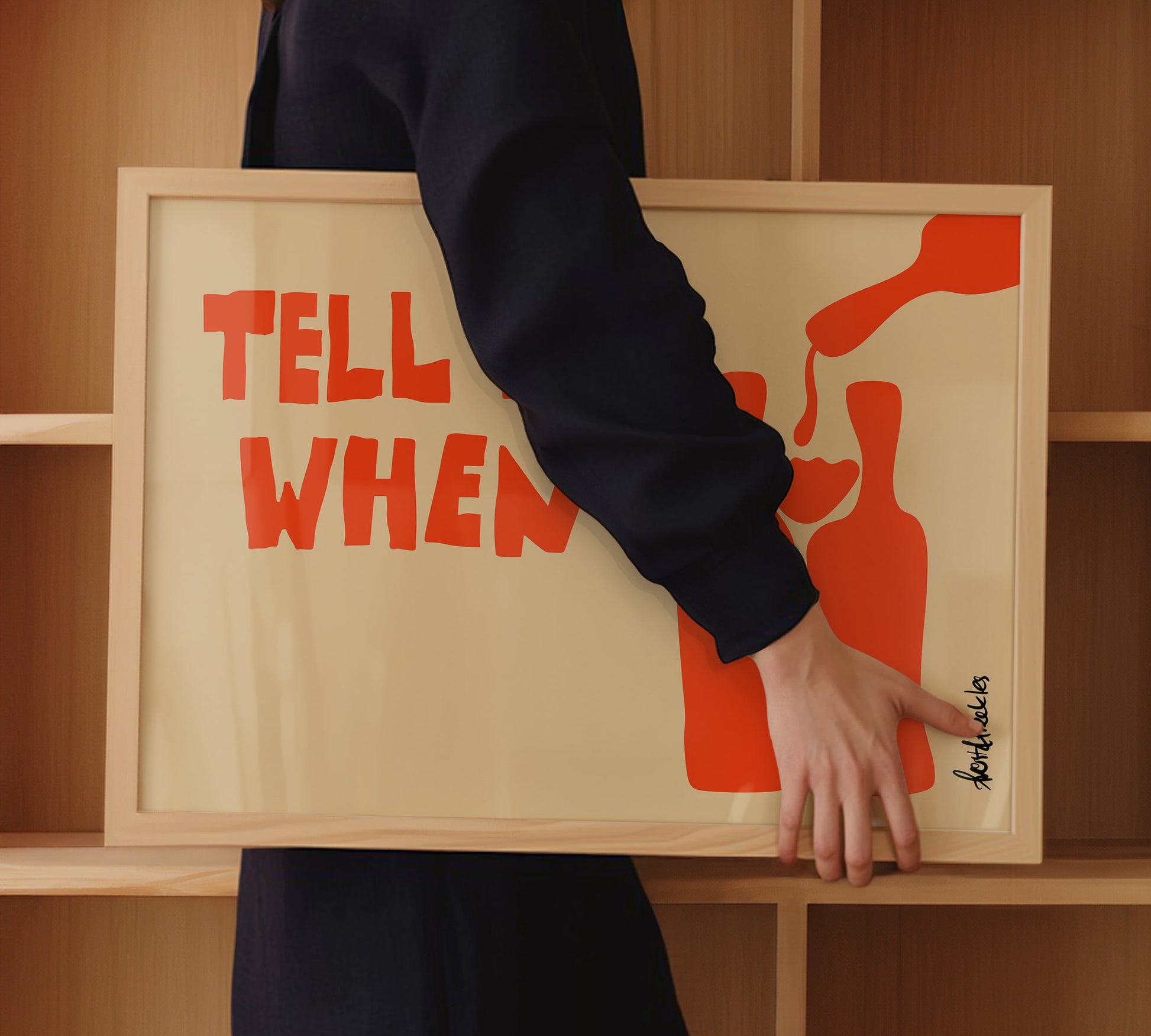 Framed wine poster with "Tell Me When" text as part of a modern kitchen nook