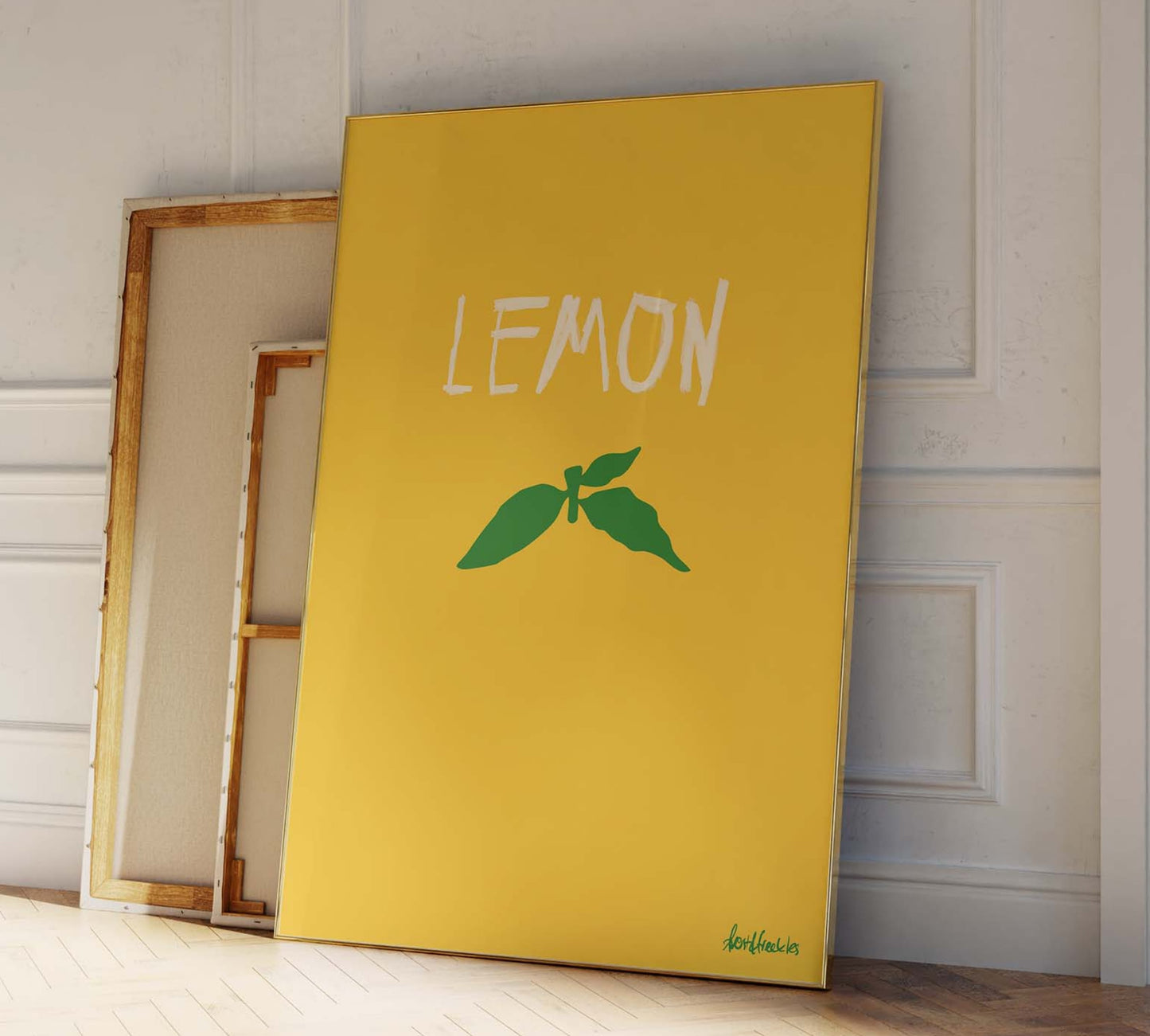 Minimal lemon illustration, framed print leaning against modern kitchen wall.