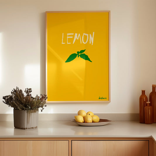 Minimalist lemon poster print with green stem design in a modern kitchen setting with lemons on counter.
