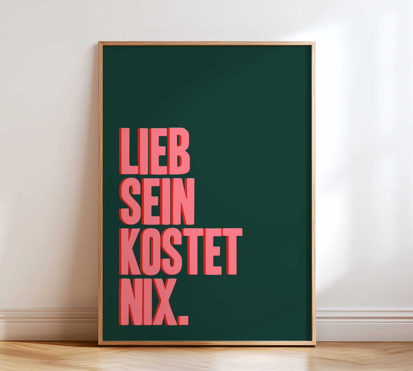 Typografie Poster mit dem Spruch "Lieb sein kostet nix" in Grün und Pink