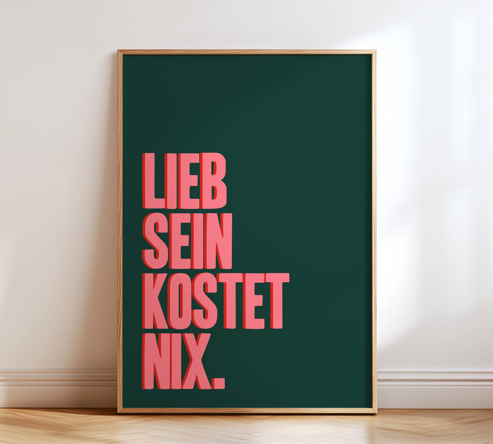 Typografie Poster mit dem Spruch "Lieb sein kostet nix" in Grün und Pink