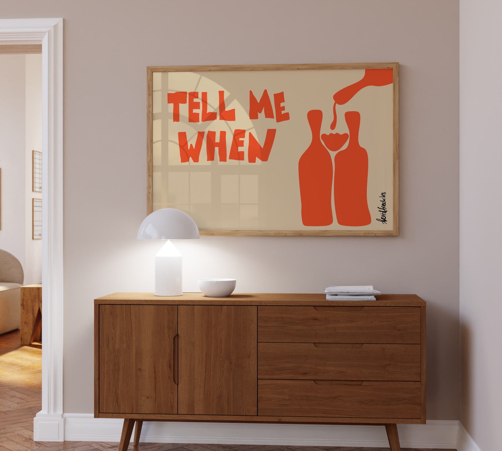 Bold typography wine print hanging above a kitchen bar cart and boho lamp