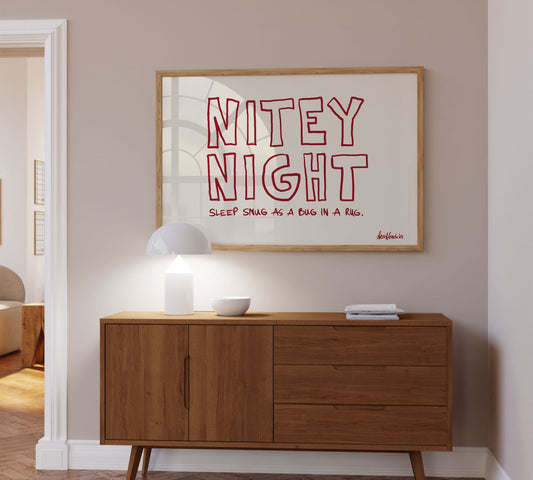 A bold red framed picture hanging above a sideboard, Danish minimalist design reading "Nitey Night" and "Sleep Snug As A Bug In A Rug".