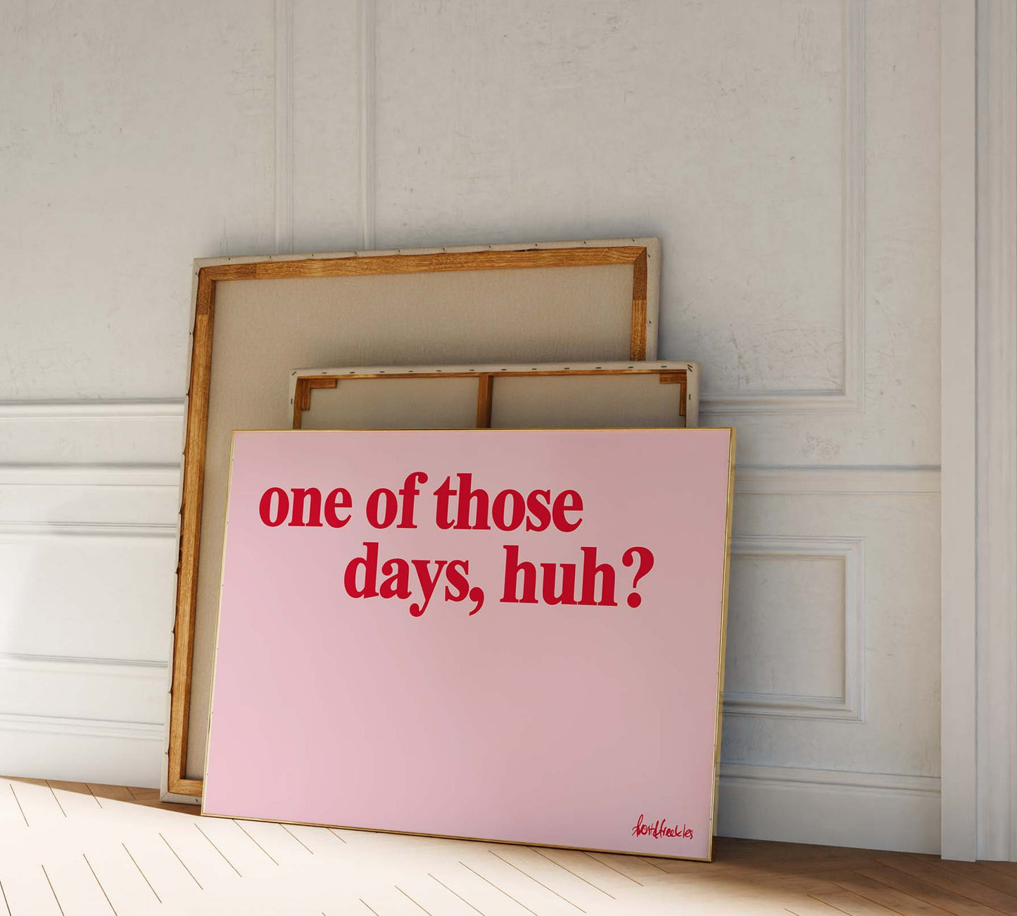 A picture frame leaning against a wall, bold red pink lettering reading "one of those days".