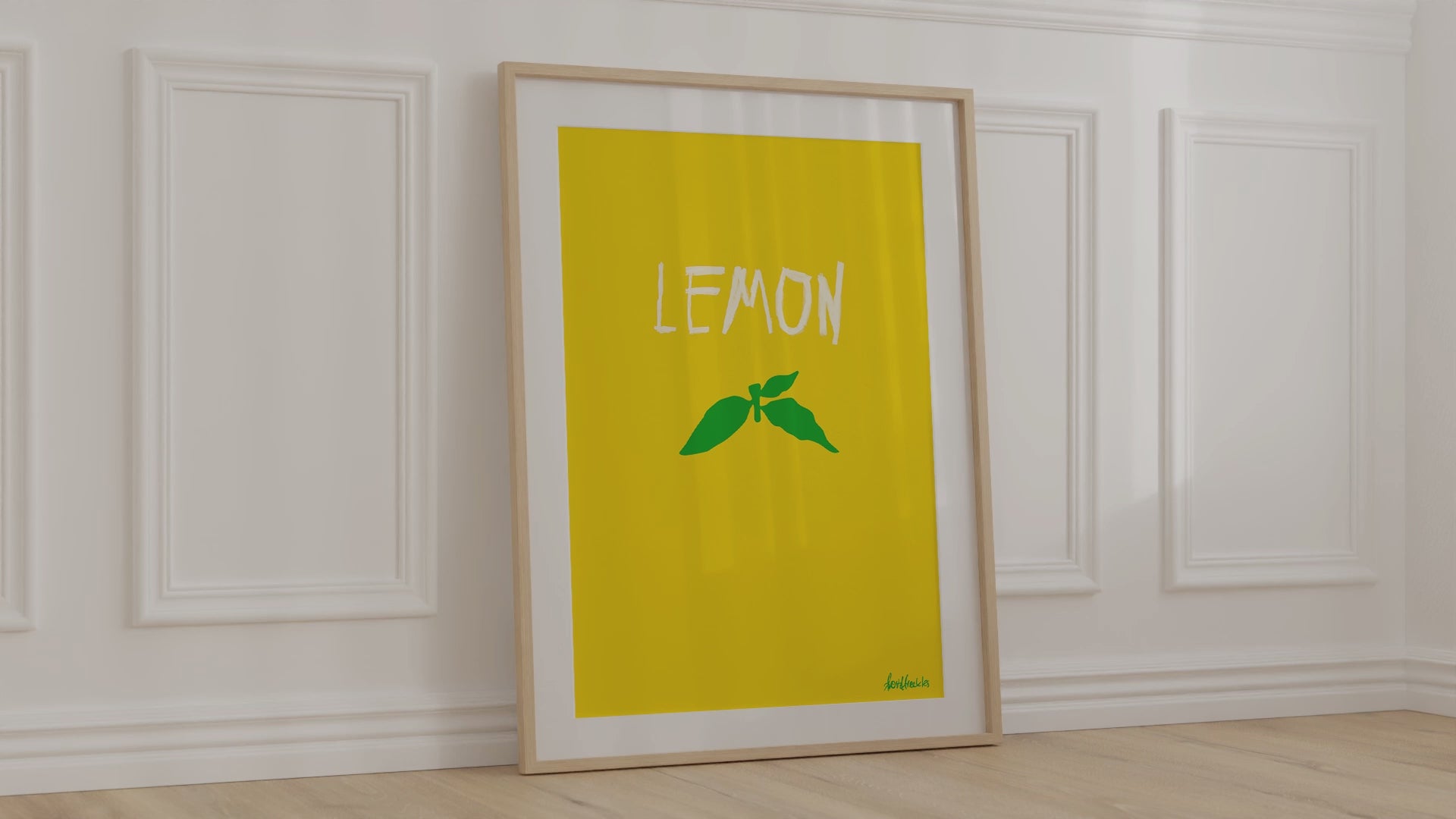Lemon themed, framed print leaning against kitchen wall with soft, warm wind blowing kitchen curtains around
