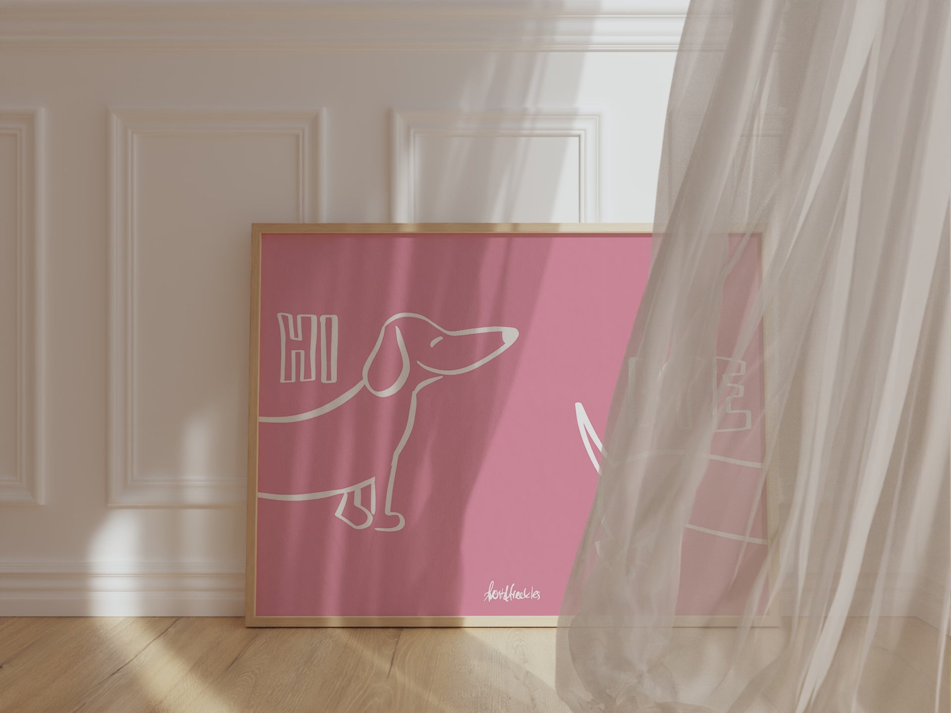 A framed picture leaning against a hallway wall, pink background and bold white letters reading "Hi Bye" with cute Dachshund illustration in center.
