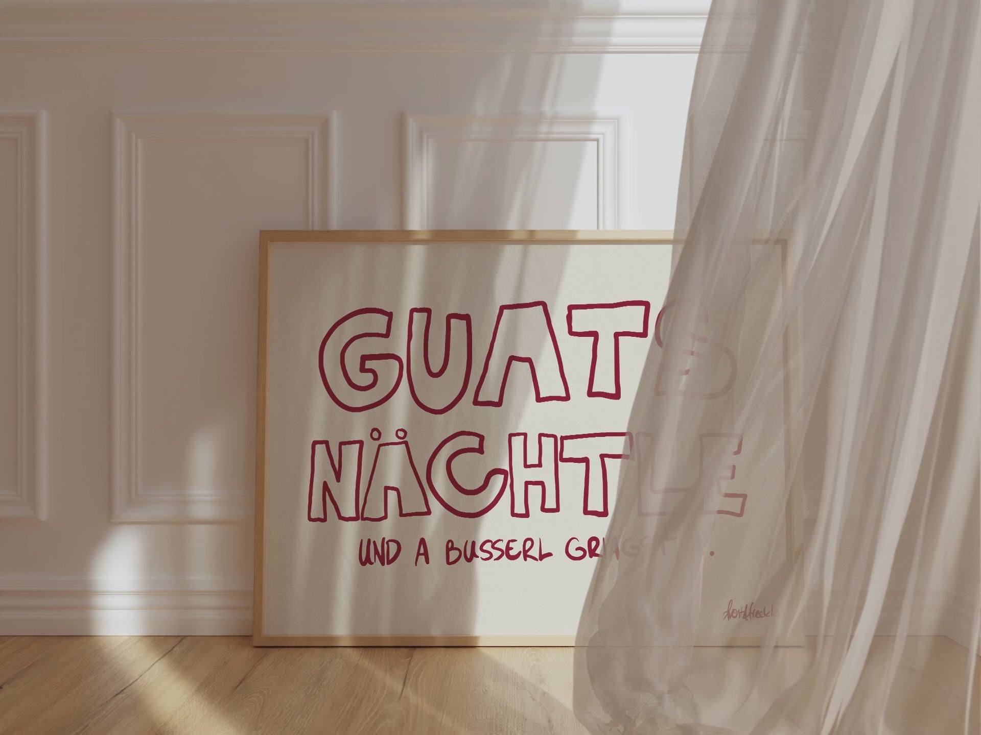 Gerahmtes Poster in horizontalem Format zeigt den Spruch "Guats Nächtle" bzw. "Gute Nacht" in roter Schrift auf pinkem Hintergrund.