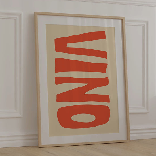 A modern, minimalist print of the Italian word "VINO" for wine in big bold orange letters on a warm beige background.